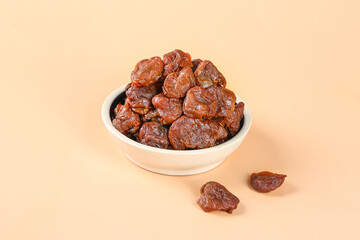 Dried Lychee Fruits from Gaozhou China in White Bowl - Traditional Asian Dried Fruit Snack with Thick Flesh and Cinnamon Flavor