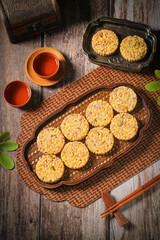 Spiced Multigrain Potato Biscuits with Purple Sesame Seeds and Tea on Rustic Wooden Table