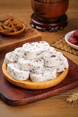 Traditional Chinese Eight Treasure Cakes with Nuts and Sesame Seeds on Wooden Plate