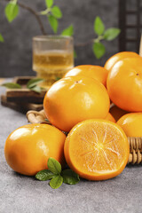 Fresh Fuping Persimmons from Yunnan China Sweet Orange Fruit in Rustic Kitchen Setting with Tea