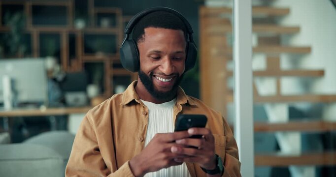 Black man, happy and headphones in office with phone, break or listen to music at company. African person, smartphone and dance with streaming subscription, audio or mobile app at creative agency - Powered by Adobe