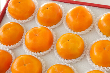Fresh Orange Persimmons in White Protective Packaging Box Ready for Gift or Market Sale
