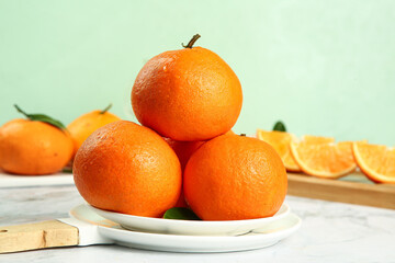 Fresh Orange Citrus Fruits Stacked on White Plate with Natural Light Photography