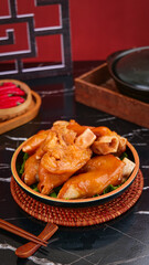 Traditional Asian Marinated Pigs Feet Delicacy in Ceramic Bowl with Chopsticks