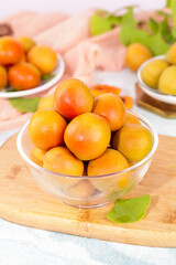 Fresh Xinjiang Apricots in Glass Bowl - Small Orange Red Stone Fruits on Wooden Board