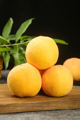 Fresh Golden Peaches on Wooden Board with Green Leaves - Summer Fruit Still Life