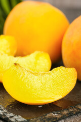 Fresh Yellow Peach Slices with Fuzzy Skin on Rustic Wood Surface