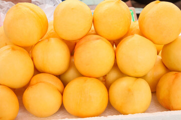 Fresh Yellow Peaches in Piles at Market Display - Ripe Summer Stone Fruit
