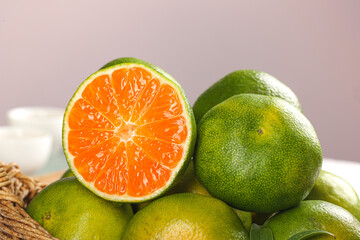 Fresh Green Yichang Honey Oranges Closeup with Seedless Segments and Textured Peel