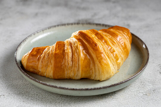 Delicious fresh croissants on the table, close-up