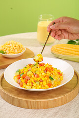 Gourmet Fresh Corn Salad with Ham and Mixed Vegetables on Wooden Platter