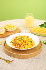Fresh Gourmet Corn Salad with Mixed Vegetables on Wooden Serving Tray