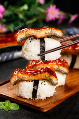 Grilled Eel Kabayaki Sushi with Teriyaki Glaze on Wooden Board - Traditional Japanese Cuisine