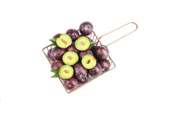 Fresh Purple Plums in Wire Basket - Whole and Halved Organic Stone Fruit on White Background