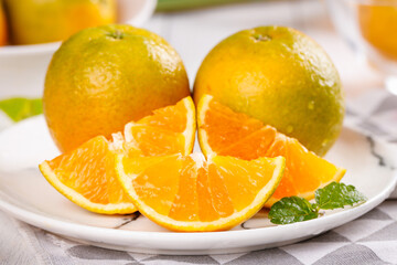 Fresh Guangxi Oranges with Sliced Segments on White Plate - Sweet Summer Citrus Fruit