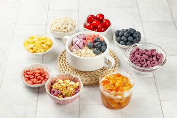 Healthy Oatmeal Breakfast Bowl with Fresh Berries and Nutritious Toppings on White Wood Background