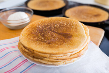 stack of appetizing flour pancakes in the kitchen during cooking