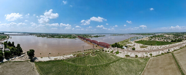 A 180-degree aerial panorama of a steel bridge over the Satluj River, located in Pakistan's Punjab...