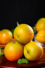 Fresh Sweet Oranges from Guangxi Hongjiang with Mint on Wooden Table - Pure Citrus Fruit Juice Burst