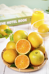 Fresh Sweet Oranges from Guangxi China in Basket with Orange Juice Glass Summer Healthy Food Concept