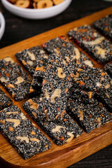 Handmade Nutritious Sesame Walnut Energy Bars on Wooden Board - Healthy Homemade Snacks