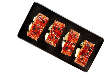 Grilled Eel Sushi with Teriyaki Glaze on Black Slate Plate White Background
