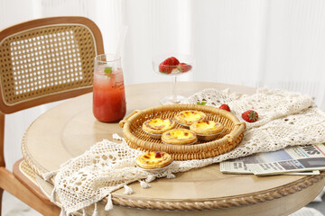 Portuguese Egg Tarts Pastéis de Nata on Table with Strawberry Drink and Lace Tablecloth