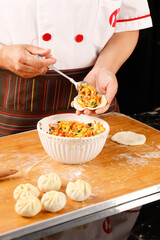 Chef Preparing Steamed Buns with Rich Vegetable Fillings in Professional Kitchen