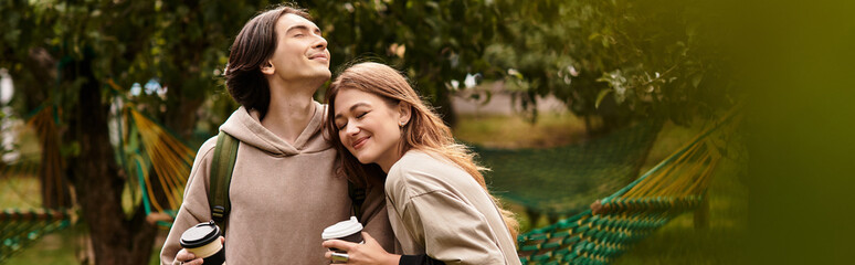 Young couple enjoys a cozy moment in a beautiful outdoor setting on a sunny day