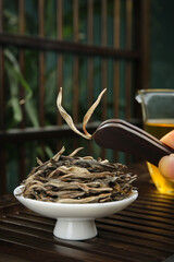 Premium Puerh Tea Leaves Ready for Brewing with Traditional Chinese Teapot on Bamboo Mat