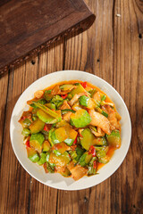 Asian Stir Fry Vegetables with Pumpkin and Bell Peppers in White Bowl on Wooden Background