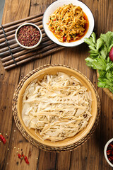 Dried bamboo shoots with rice noodles and Asian spices on wooden background - traditional oriental cuisine ingredients