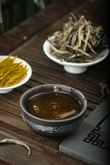 Traditional Chinese Puerh Tea Ceremony Setup with Dried Leaves and Brewing Accessories