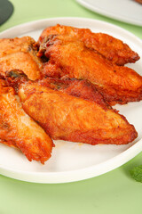 Crispy Fried Chicken Wings with Golden Brown Skin on White Plate - Gourmet Comfort Food