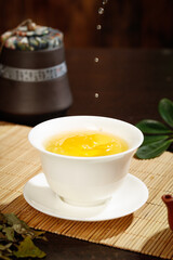 Premium Fuding White Needle Tea Tasting Ceremony in Traditional Chinese Porcelain Cup on Bamboo Mat