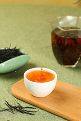 Ancient Puerh Black Tea Brewing Ceremony with Traditional Chinese Teaware on Green Background