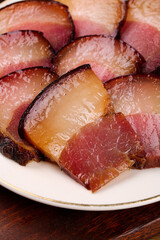 Five Slices of Smoked Salted Pork with Rich Flavors on Wooden Table