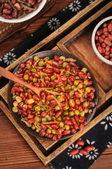 Flavored Mixed Peanuts and Peas Snack in Wooden Bowl with Chopsticks