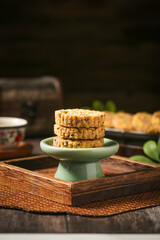 Traditional Hakka Potato Nut Pastries with Sesame Seeds on Green Ceramic Stand - Fried Breakfast Treats