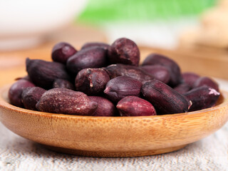 Purple-Skinned Peanuts in Wooden Bowl on Rustic Board - Fresh Organic Legumes for Healthy Cooking