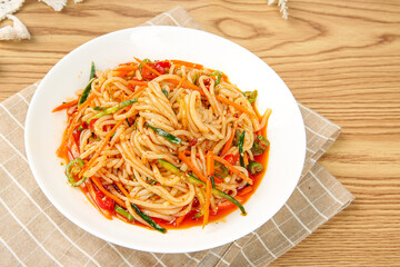 Spicy Konjac Rice Noodles with Vegetables in White Bowl on Wood Background