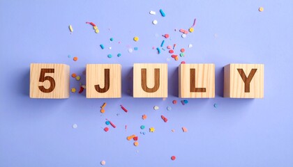 Wooden Blocks with Date 5 July. Calendar for birthday or anniversary on solid colored background with confetti