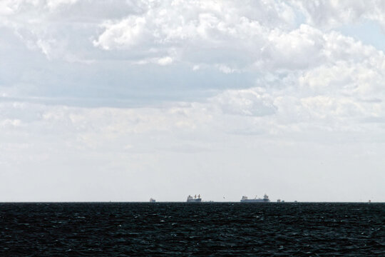 Cargo ships waiting in the open sea, rough seas