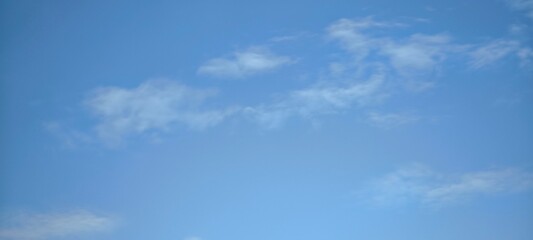 blue sky with white clouds. The sky is clear and bright