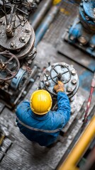 A skilled industrial worker operates machinery in a factory setting.