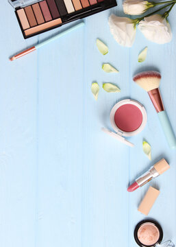 cosmetics and flowers on a colored background top view.. Vertical photo format