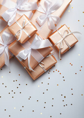 Gifts in gold packaging on a colored background with place for text.. Vertical photo format