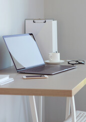 Workplace with modern laptop in the interior of the room. Vertical photo format
