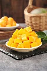 Fresh Diced Mango Chunks in Bowl on Slate Board - Tropical Fruit Preparation
