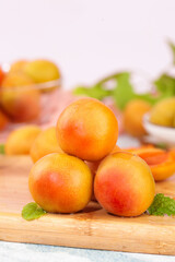 Fresh Xinjiang Apricots on Wooden Board with Mint Leaves - Healthy Organic Stone Fruit